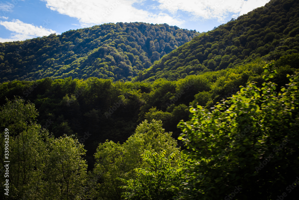 Mountains rocks a relief a landscape a hill a panorama Caucasus top a slope clouds the sky a landscape