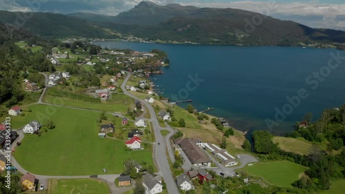 4K revealing drone motion shot of the little villige Strandebarm in the beautiful Hardanger fjords in Norway. photo