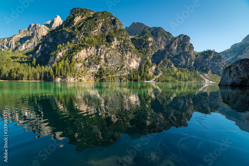 Beautiful reflections in the crystal clear turquoise lake Pragser Wildsee in Lago di Braies, South Tyrol
