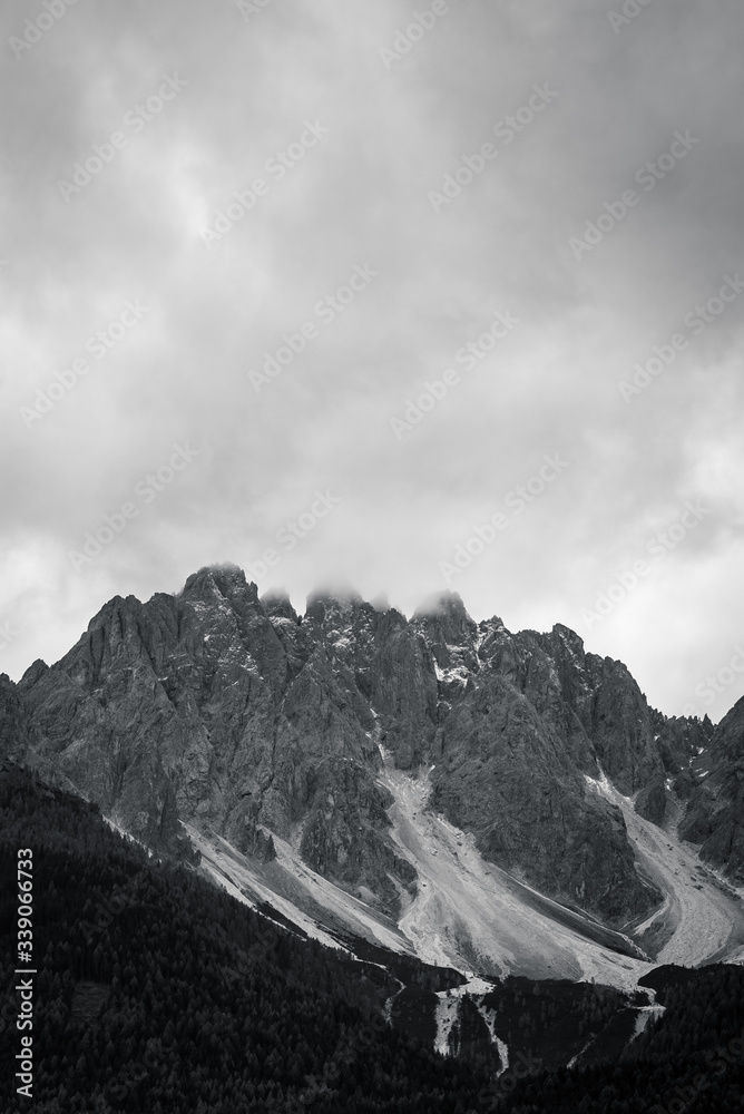 Black and White Scenic view of clouds above The dolomites mountain peaks in the Italian town of San Candido in South Tyrol, Northern Italy