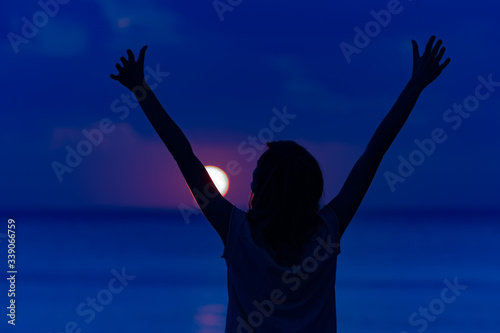 Woman with arms wide open enjoying ocean tropical time.