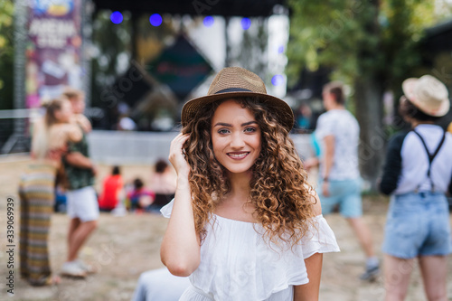 Beautiful young girl at summer festival, looking at camera. © Halfpoint