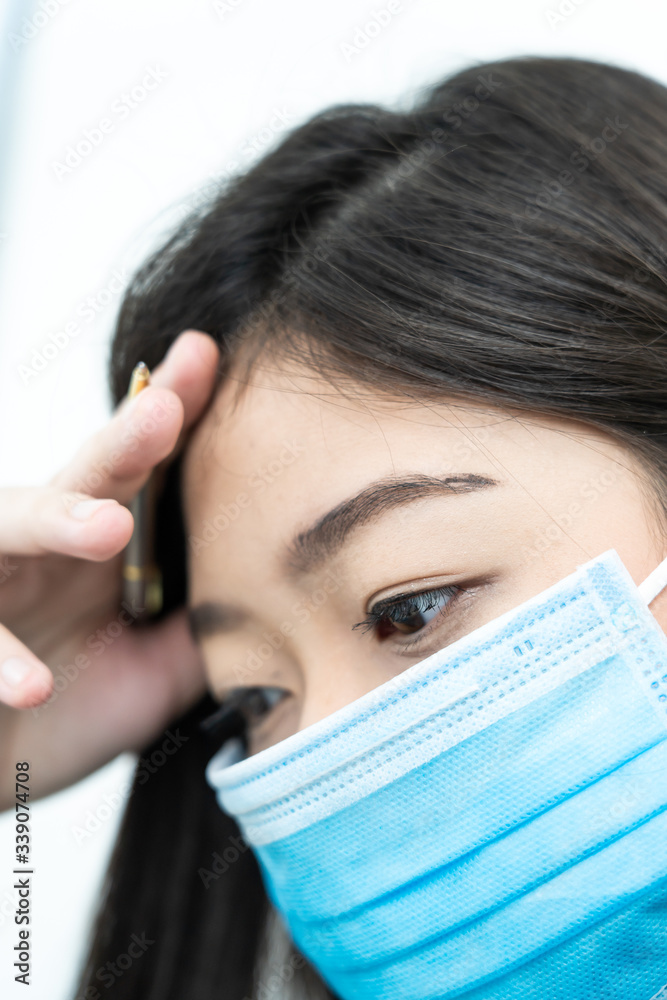 Close up woman with headache wearing mask for protect Covid-19 Close up woman with headache wearing mask for protect Covid-19
