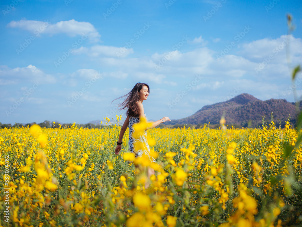 Young happy girl walking on the flower field and enjoying fresh air. Young happy girl walking on the flower field and enjoying fresh air.