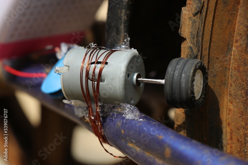 DC Motor which is modified to work as a dynamo attached to bicycle wheels 