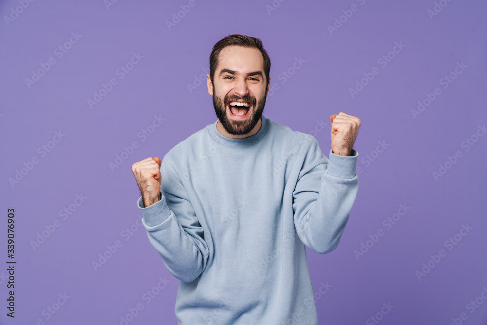 Positive happy young man showing winner gesture. Positive happy young man showing winner gesture.