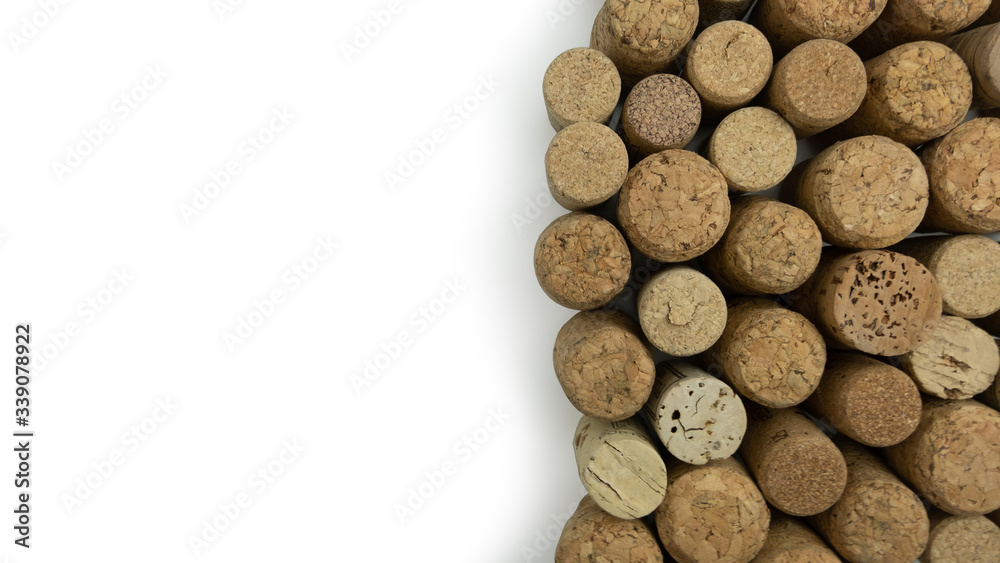 Wine corks with copy space on left. Many different corks, top down shot, on white background. Wine corks with copy space on left. Many different corks, top down shot, on white background.