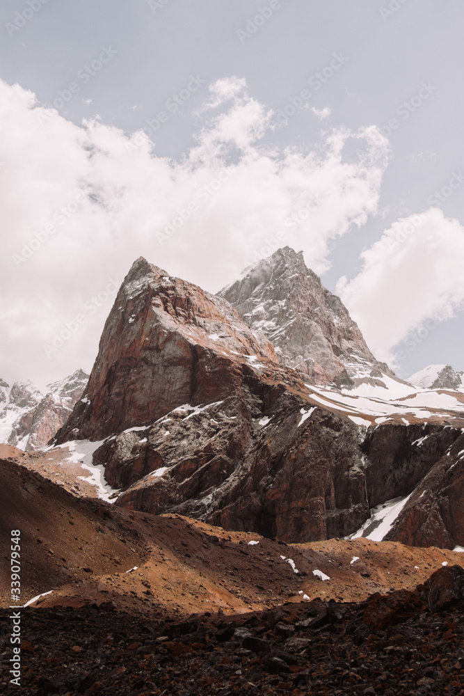 Tajikistan. Fann mountains Summer. An interesting brown mountain covered with snow.