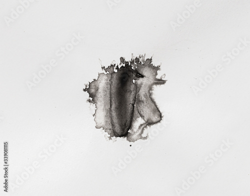 abstract black splashes on white watercolor paper. monochrome image.