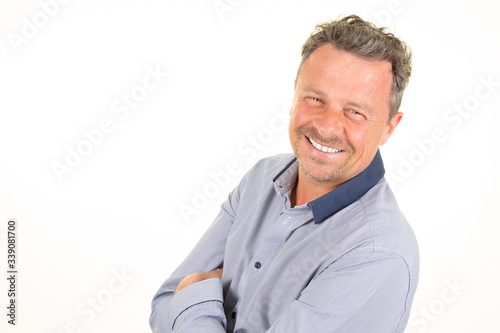Portrait of happy handsome laughing businessman smiling with arms crossed aside white copy space background © OceanProd