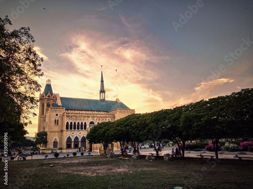 church at sunset with historical building photo