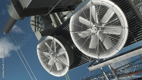 Large fan blades in a power transformer cooling system. Camera rotation around its axis.