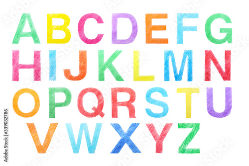 Set of letters written with color pencils on white background, top view