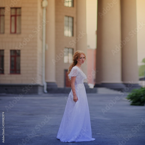 beautiful girl in a vintage dress walks in the city