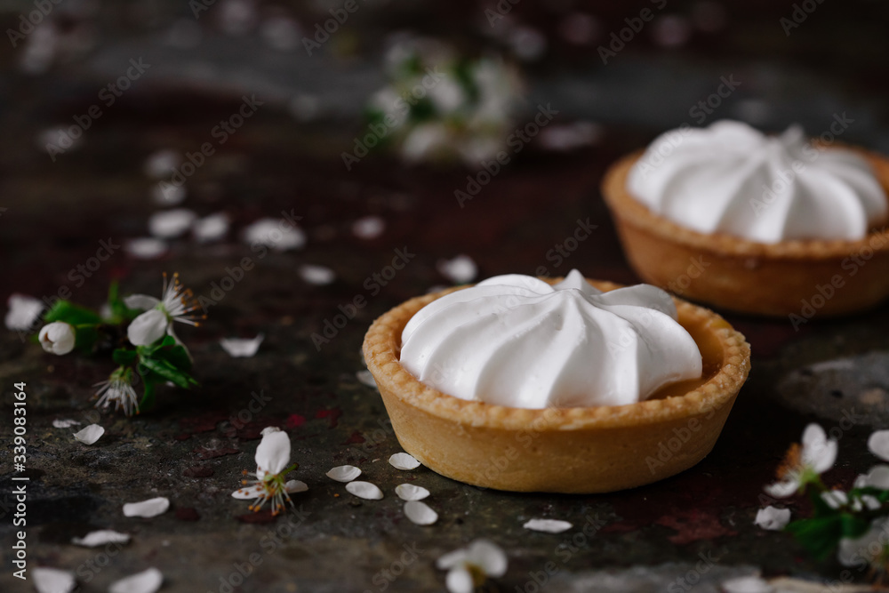 lemon cheesecake pie on wooden background with flower petals lemon cheesecake pie on wooden background with flower petals