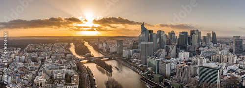 Aerial pano drone shot of La Defense skyscraper complex by la Seine with Pont Neuilly during sunset hour
