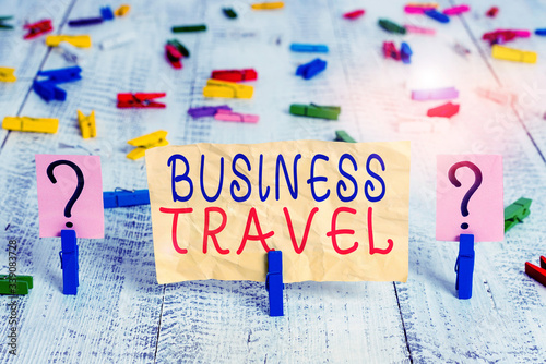 Conceptual hand writing showing Business Travel. Concept meaning travel on behalf of a company to one or more destinations Crumbling sheet with paper clips placed on the wooden table photo