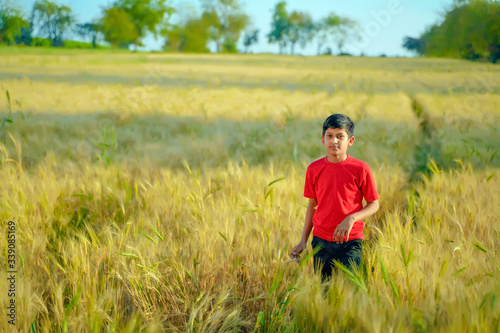 young indian child playing at wheat field, Rural india © PRASANNAPIX
