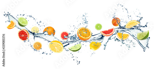 Different fresh citrus fruits and splashing water on white background. Banner design