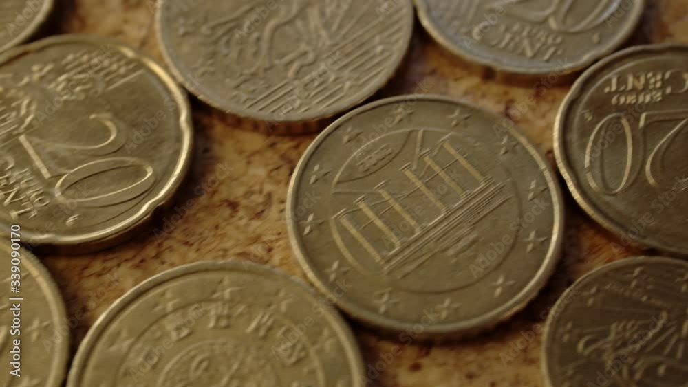 some golden euro cent penny coins laying on the ground camera moving backwards some golden euro cent penny coins laying on the ground camera moving backwards
