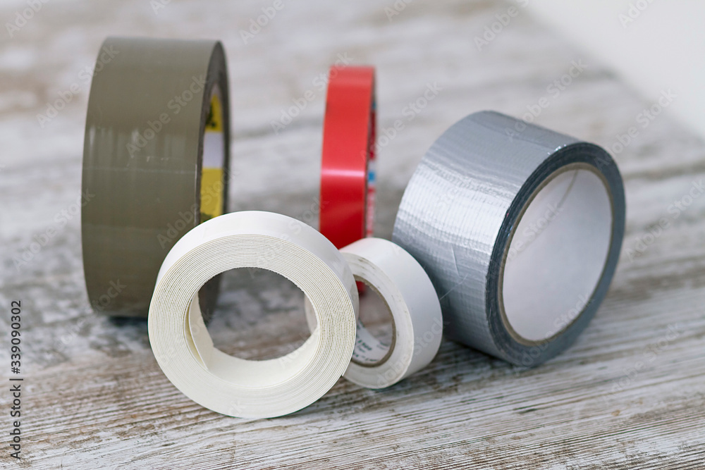 Rolls of adhesive tape of different types - obrazy, fototapety, plakaty 