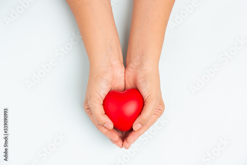 Fototapeta Naklejka Na Ścianę i Meble -  Woman doctor hands holding red heart on wide blue background donate for foundation hospital blood care concept Panoramic world heart and health day, People CSR community, foster support children organ