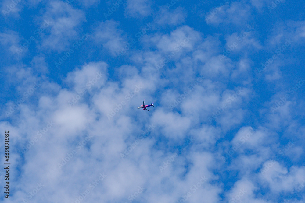Commercial passenger airplane in the blue sky