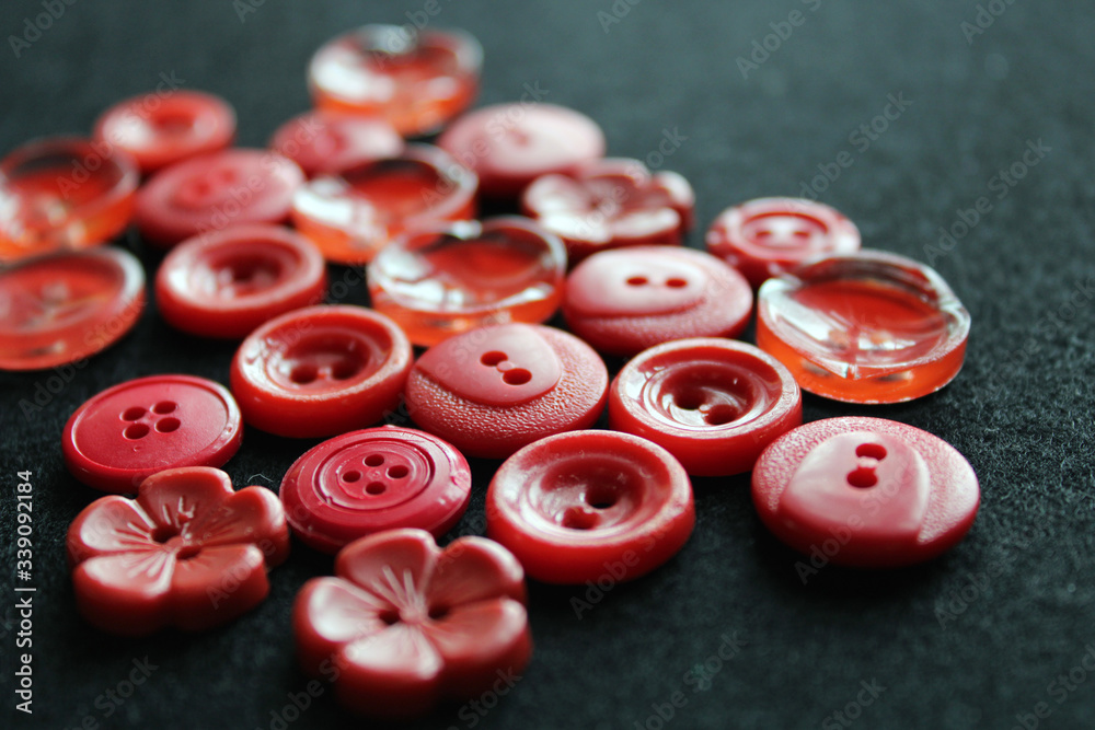 Red buttons of different shapes. Hardware. Black background. Close-up. The inscription in Russian Red buttons of different shapes. Hardware. Black background. Close-up. The inscription in Russian