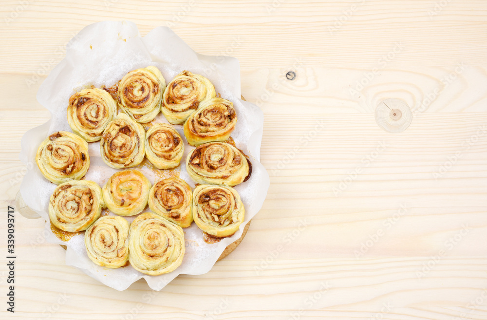 Homemade puff pastry cinnamon rolls served with green tea as breakfast, Czech republic, Europe. Homemade puff pastry cinnamon rolls served with green tea as breakfast, Czech republic, Europe.