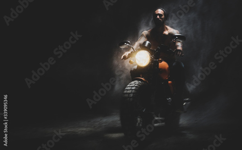 Moto rider on the dark empty road
