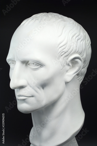 julius caesar roman emperor gypsum bust on black background
