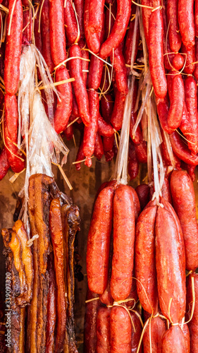 Red sausages and other dry meat hanging under the sun