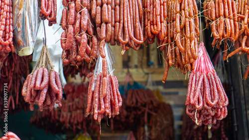 Photography Many kinds of dry sausages hanging on a butcher shop in Southeast Asia