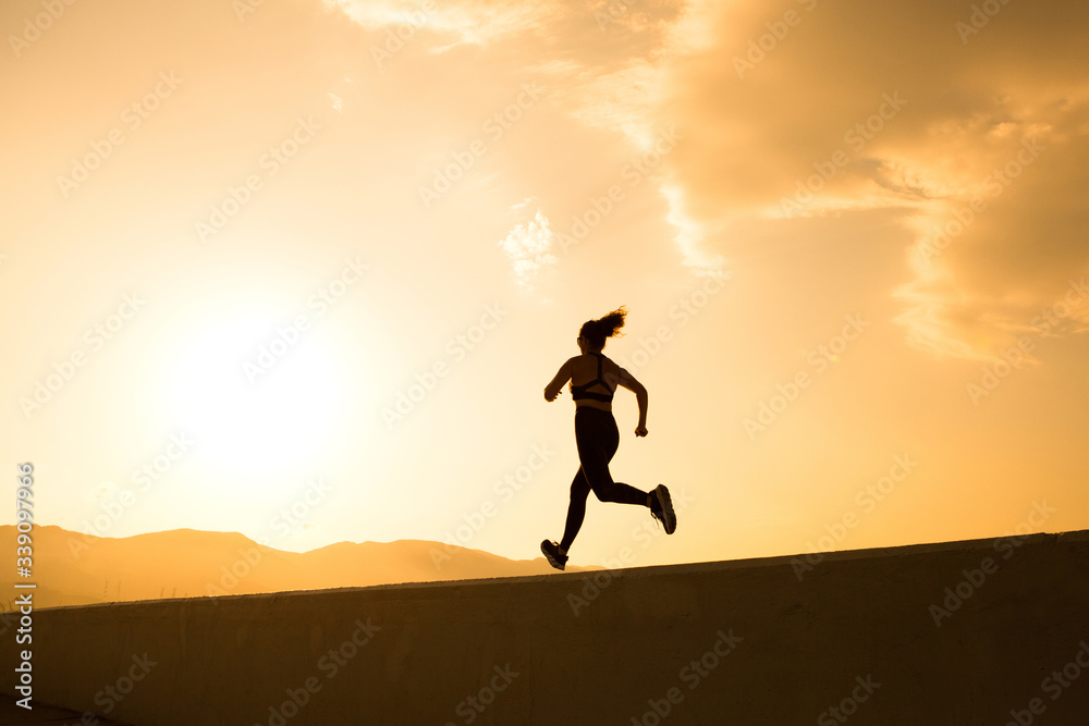 Woman is running in the morning preparing for marathon Woman is running in the morning preparing for marathon