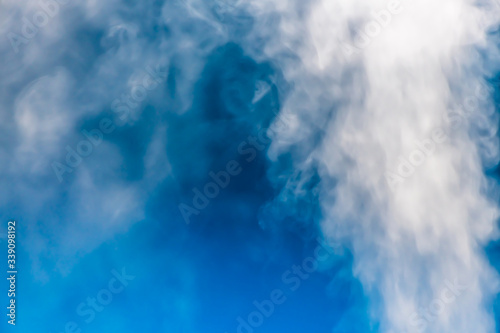 closeup steam from the air humidifier on blue background. health, disease prevention photo