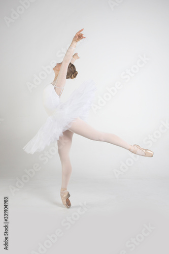 Fototapeta Naklejka Na Ścianę i Meble -  Young ballerina practising ballet moves