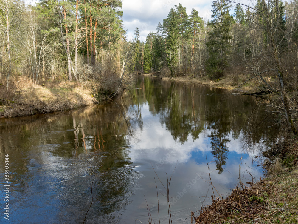 river view in early spring, beautiful cloud reflections in water river view in early spring, beautiful cloud reflections in water