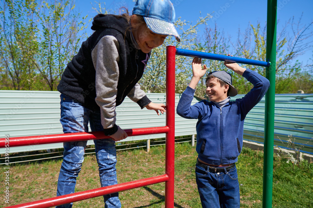 Children play on the playground next to a condominium. A place for children to play. Urban residential infrastructure. Children play on the playground next to a condominium. A place for children to play. Urban residential infrastructure.