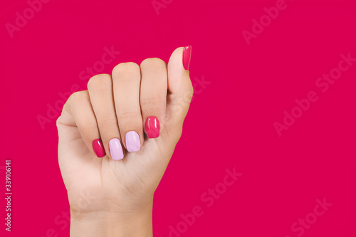 Fototapeta Closeup view photography of one manicured female hand with beautiful trendy two