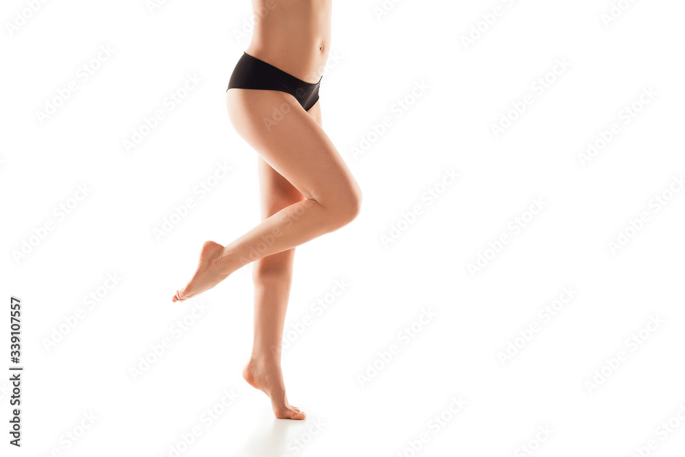Beautiful female legs, butt and belly isolated on white background. Beauty, cosmetics, spa, depilation, treatment and fitness concept. Fit and sportive, sensual body with well-kept skin in underwear.