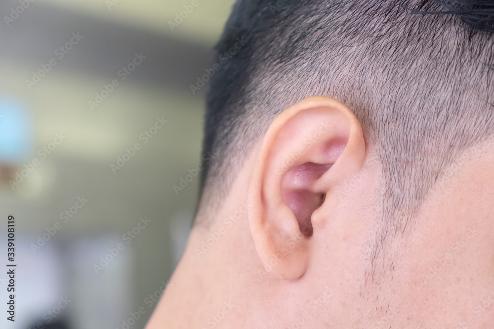 Obraz premium Close up of the right ear of a man and the place on the left side for placing letters.