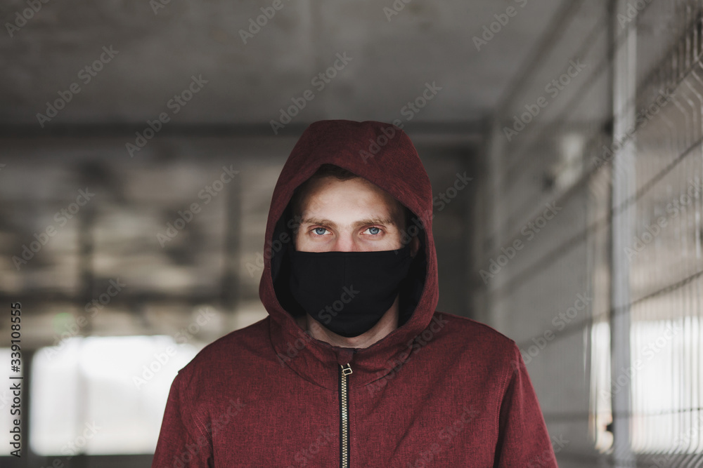 a young man in a black mask during the coronavirus pandemic