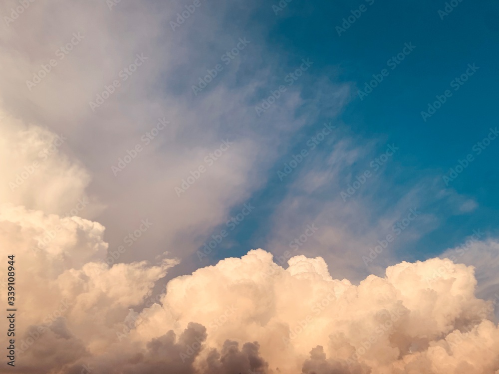 white cumulus clouds against deep blue sky