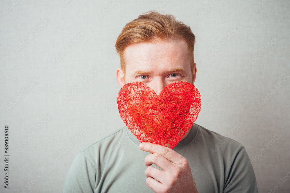 bearded man holding a heart and happy bearded man holding a heart and happy