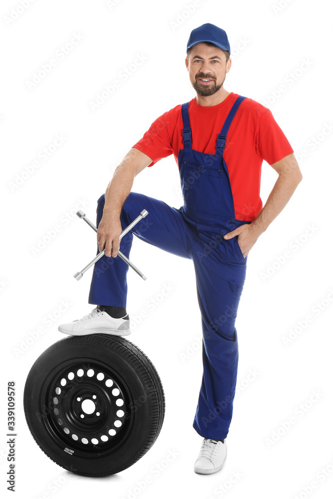 Full length portrait of professional auto mechanic with lug wrench and wheel on white background Full length portrait of professional auto mechanic with lug wrench and wheel on white background