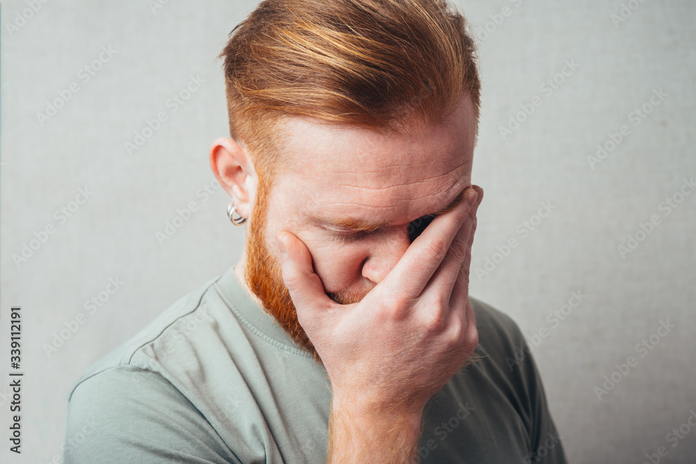 portrait of a Young red bearded Man feel bad, sad portrait of a Young red bearded Man feel bad, sad