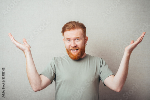 Young hipster red bearded Man with hands in the air photo