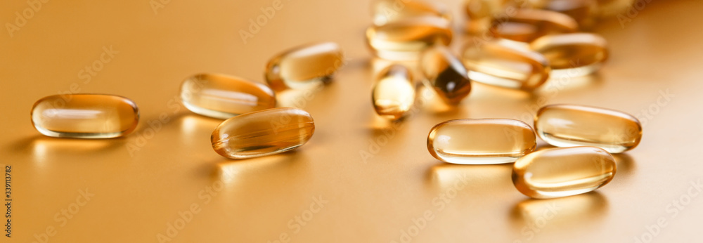 Many capsules Omega 3 on yellow background. Close up, high resolution product. Health care concept. Many capsules Omega 3 on yellow background. Close up, high resolution product. Health care concept.