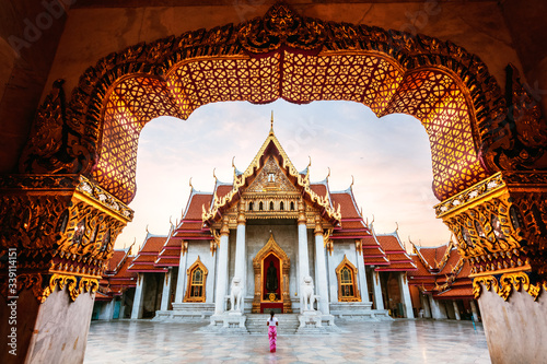 Woman in front of the Marble Temple, Bangkok, Thailand photo