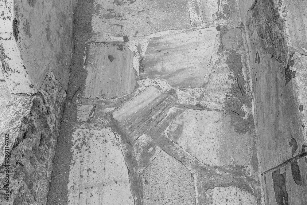 Closeup view black and white photography of old weathered marble floor texture.